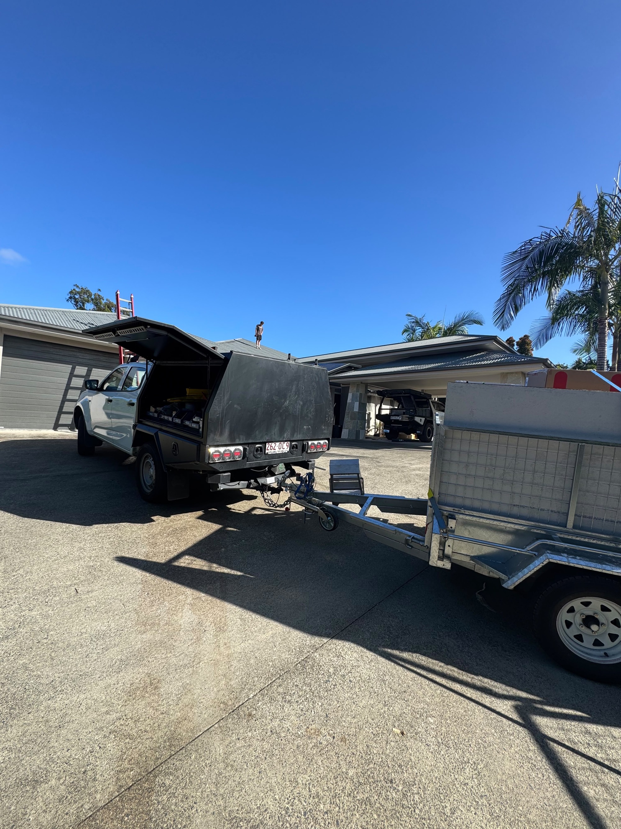 Untapped Energy dual utes and trailer on site — Boronia Heights solar panel install